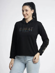 Woman wearing a black hoodie with 'GREAT' text on a white background