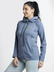 Woman wearing a blue hoodie with a visible brand logo on a white background