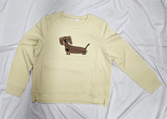 Beige sweatshirt with a dachshund graphic on a white background