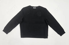Black sweater with floral patterns on a white background