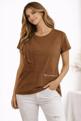 Woman wearing a brown t-shirt with a zipper detail on a white background