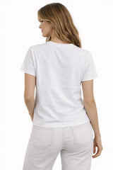Woman wearing a plain white t-shirt and light-colored pants on a white background