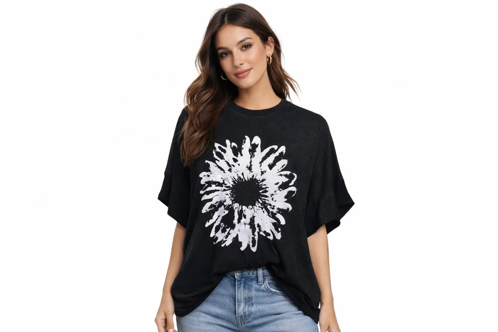 Woman wearing a black top with a white floral design