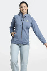 Woman wearing a blue jacket with a brand logo on a white background