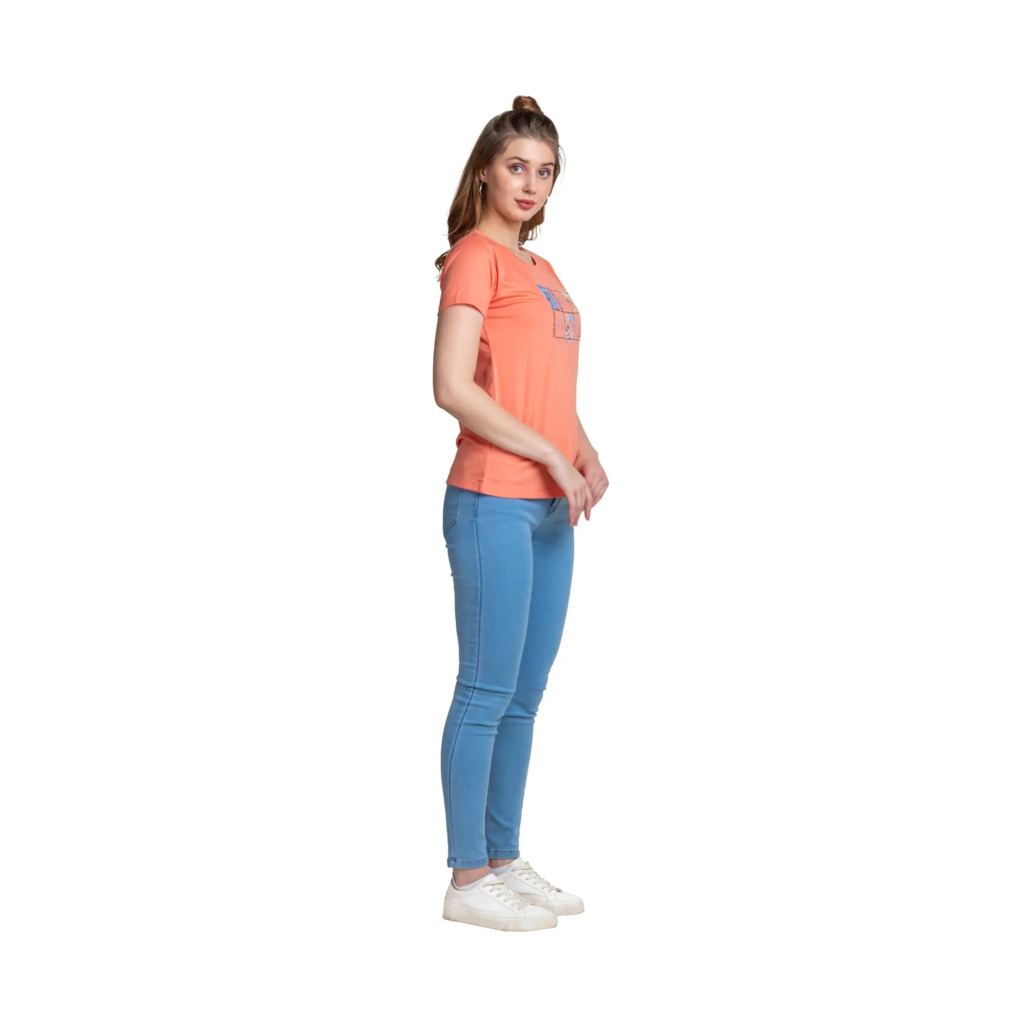 Woman wearing an orange t-shirt and blue jeans on a white background