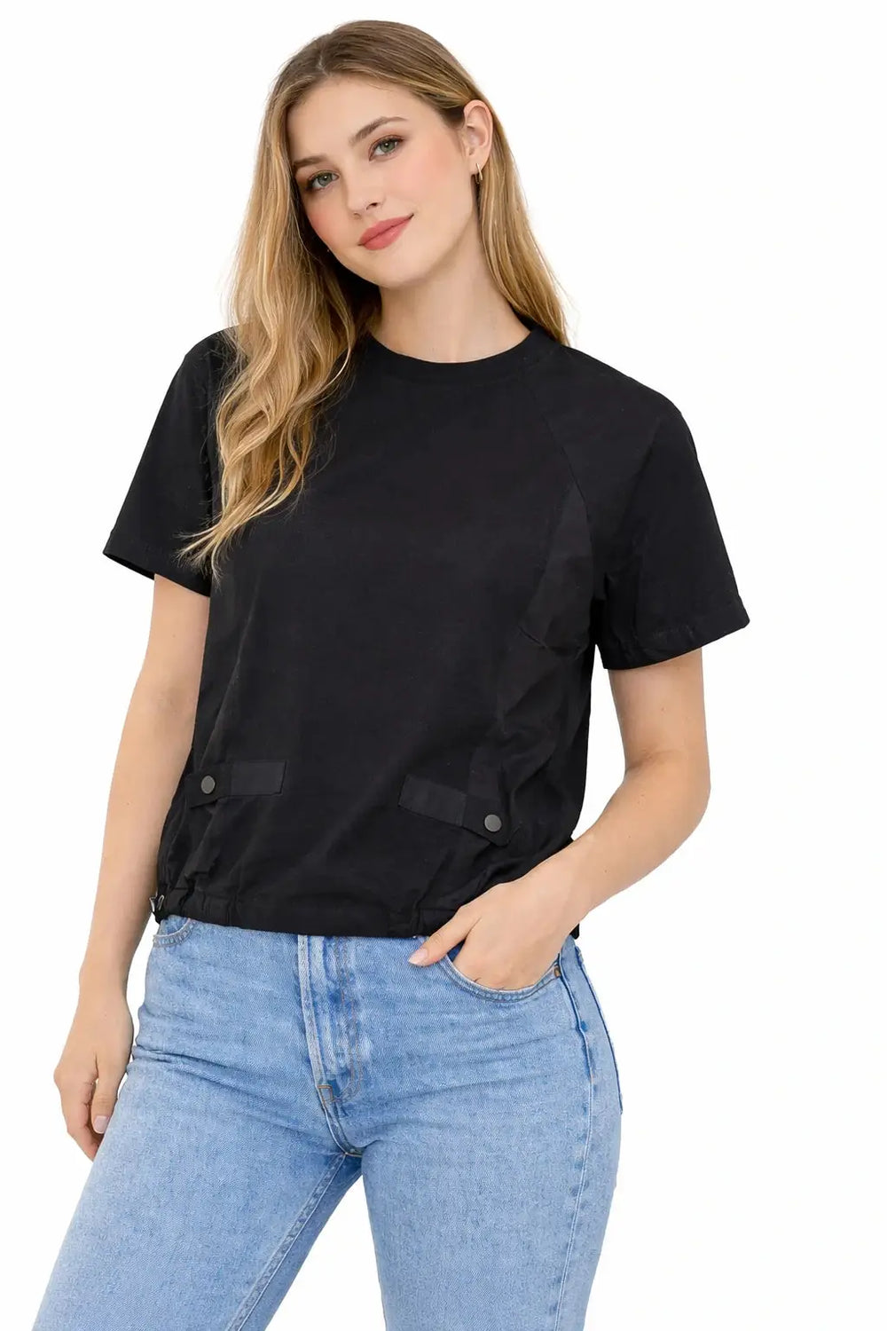 Woman wearing a black t-shirt and blue jeans on a white background