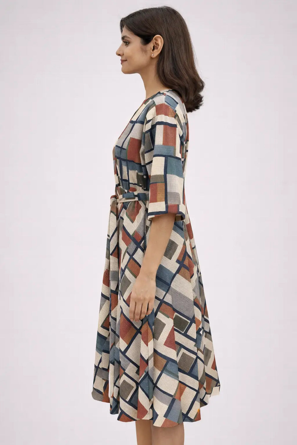 Woman wearing a patterned dress on a white background